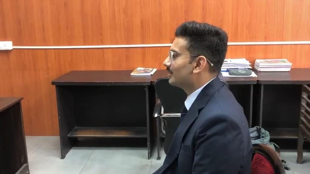 A candidate facing a mock interview board in a formal interview-like environment at Panacea